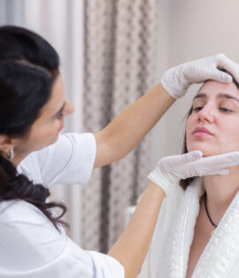 Woman receiving a facial aesthetic treatment at Glow Skin Dental Clinic